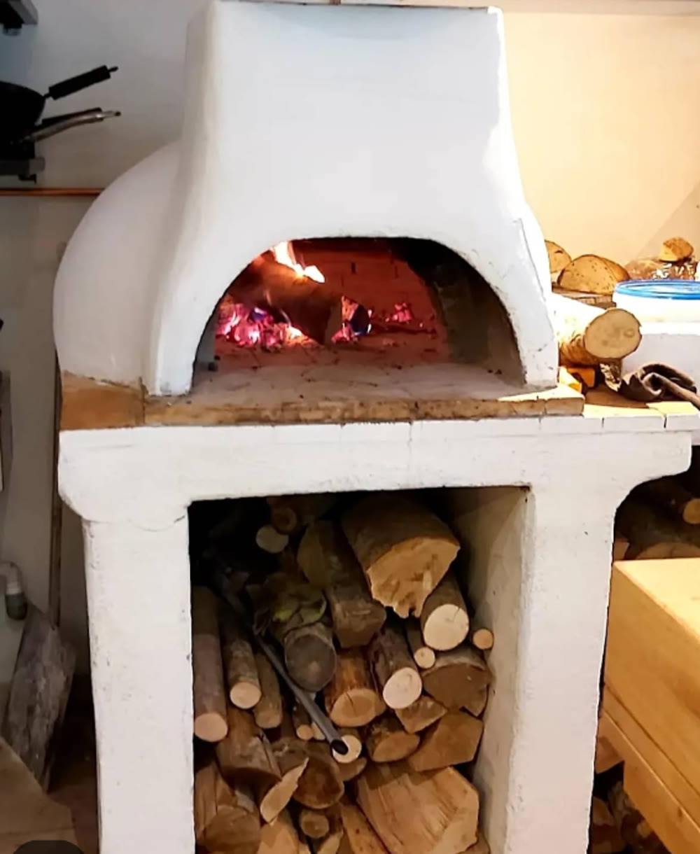 Sourdough loaves inside the glowing stone oven